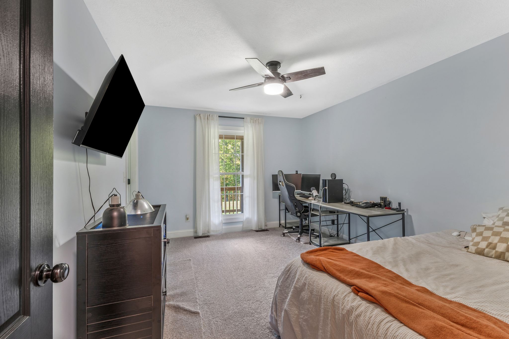 1745 Ennis Branch Road McEwen, TN 37101 - Photo 17 of 85 a bedroom with a bed and a flat screen tv