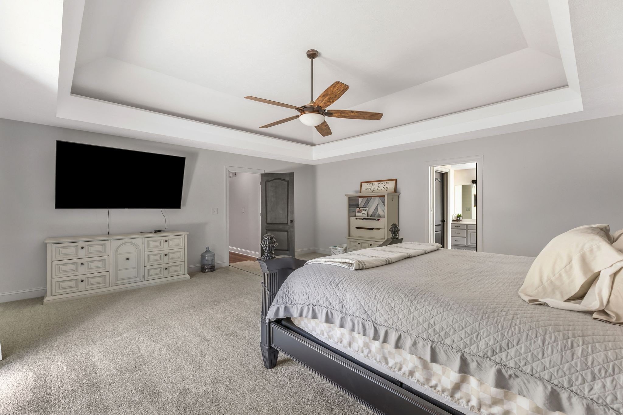 1745 Ennis Branch Road McEwen, TN 37101 - Photo 25 of 85 a bedroom with a bed flat screen tv on dresser and a chandelier