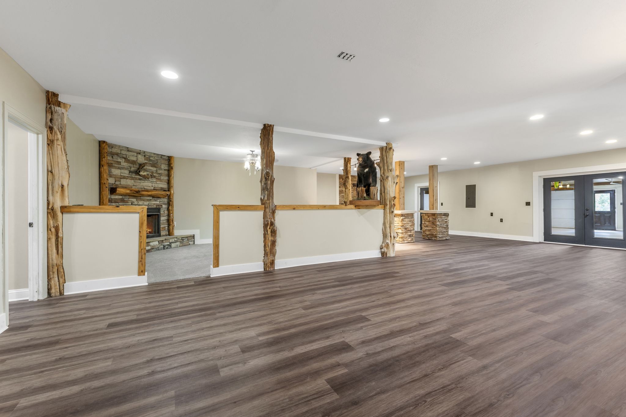 1745 Ennis Branch Road McEwen, TN 37101 - Photo 35 of 85 a view of a big room with wooden floor and a kitchen
