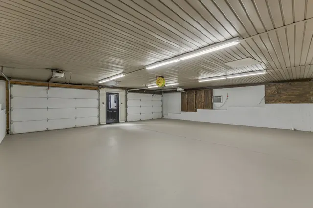 a dining room with furniture and a chandelier