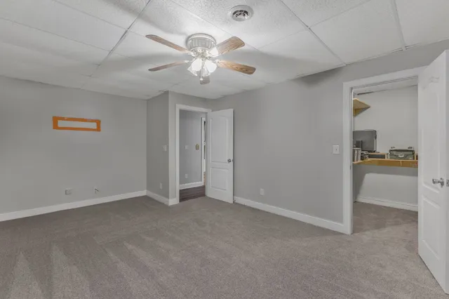 a view of a big yard with a house in the background