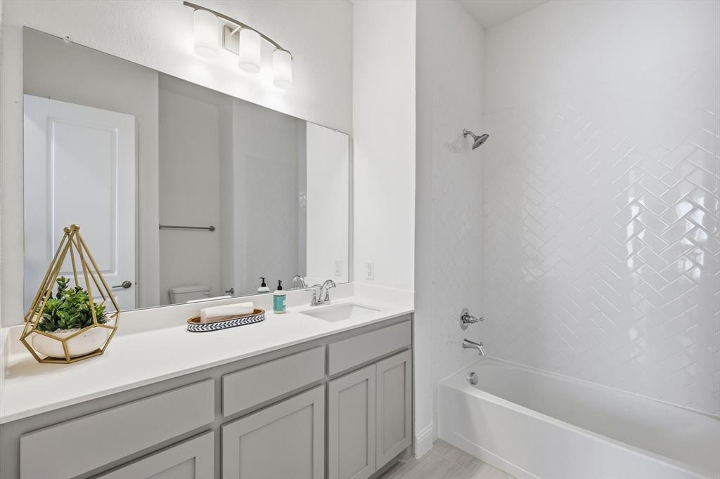 4017 Eagles Bluff Road Midlothian, TX 76065 - Photo 33 of 38 Contemporary bathroom featuring a single vanity with light gray cabinetry, a white countertop, and a rectangular undermount sink
