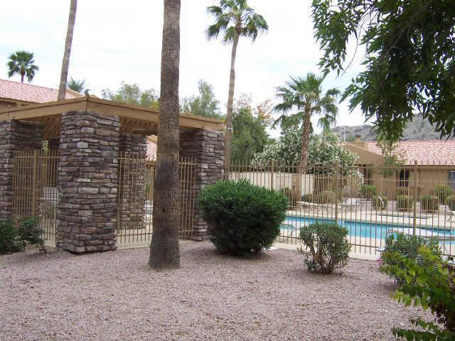 3511 East Baseline Road, Unit 1202 Phoenix, AZ 85042 - Photo 9 of 10 a view of a garden with a bench in patio