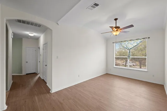 wooden floor in an empty room with a window