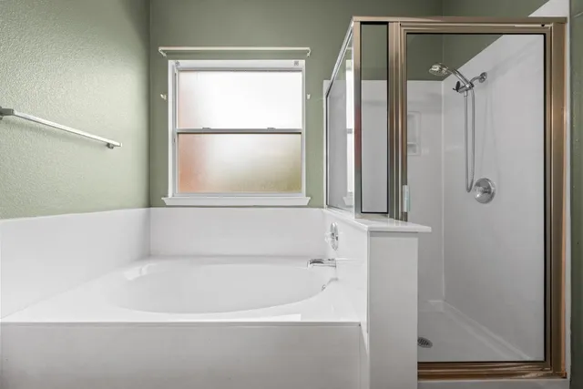 a bathroom with a bathtub and a shower