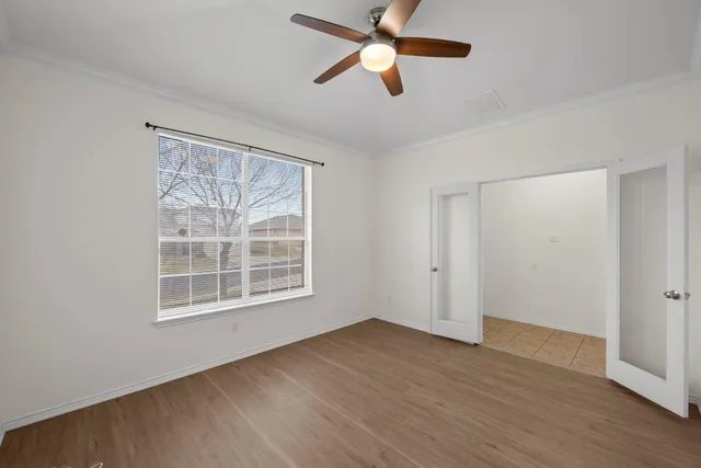 wooden floor in an empty room with a window