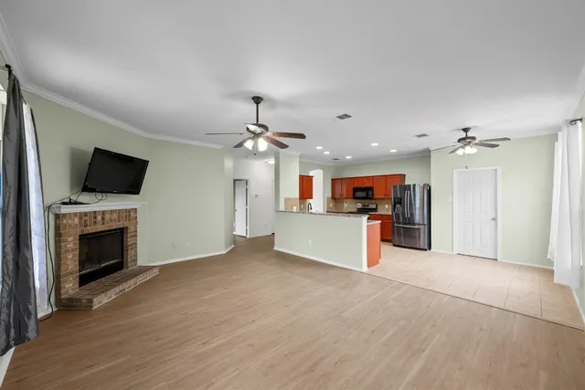a view of a kitchen with a sink a microwave and cabinets