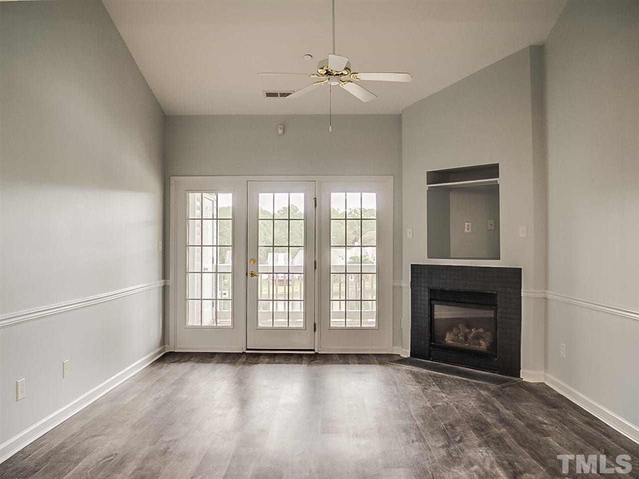 332 Springfork Drive Cary, NC 27513 - Photo 5 of 15 a view of an empty room with a fireplace and a window