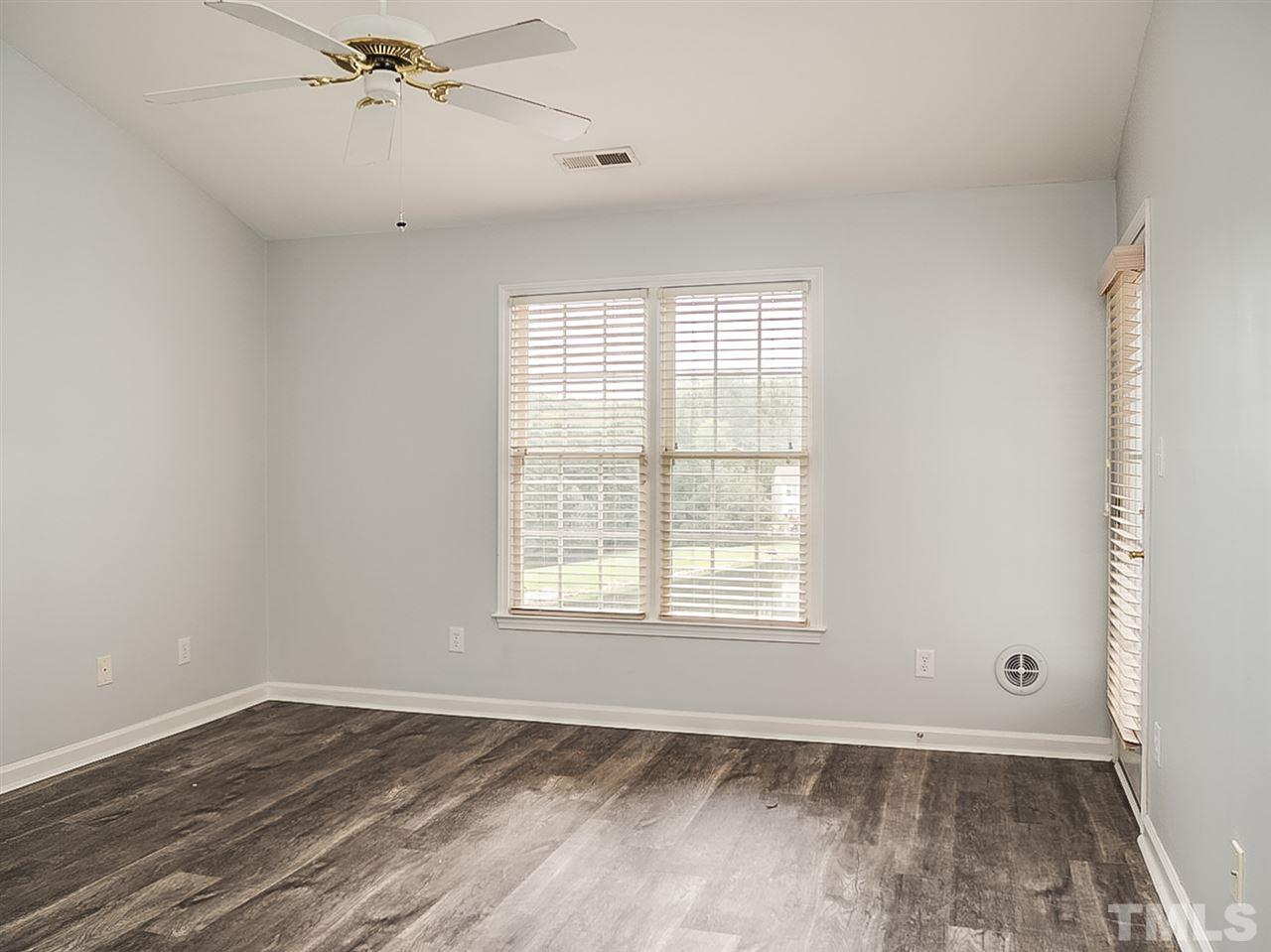 332 Springfork Drive Cary, NC 27513 - Photo 6 of 15 an empty room with wooden floor fan and windows
