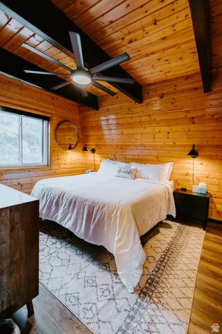1413 Basel Drive Midway, UT 84049 - Photo 80 of 137 Bedroom with a wooden ceiling with exposed beams, wood walls, a ceiling fan, and wood finished floors