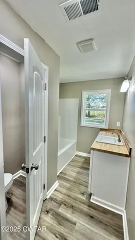 a room with a door and chandelier