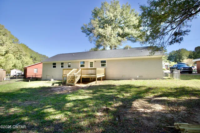 a backyard of a house with yard and outdoor seating