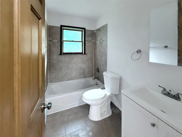 a bathroom with a toilet a sink and bathtub