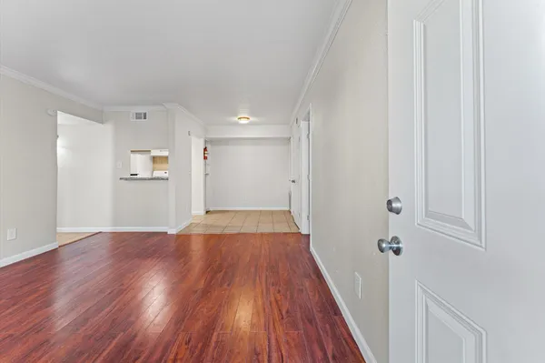 a view of a hallway with wooden floor
