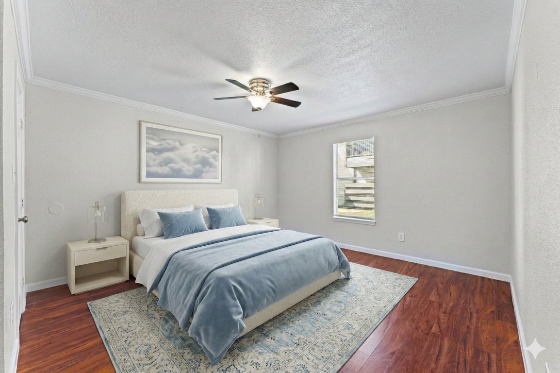 6161 Reims Road, Unit 107 Houston, TX 77036 - Photo 10 of 15 a bedroom with a large bed and a chandelier