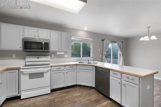 a kitchen with a sink stove and microwave