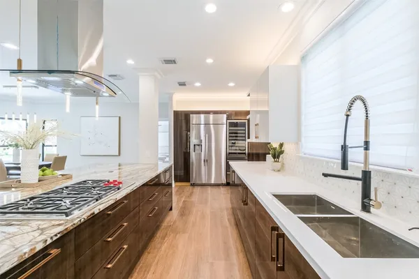 a kitchen with a stove a sink and a microwave