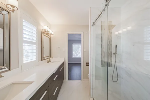 a large bathroom with a large tub and sink