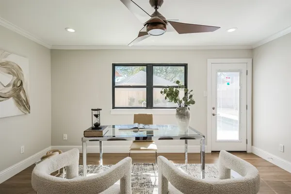 an empty room with wooden floor closet and windows