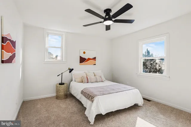 a bedroom with a large bed and a painting on the wall