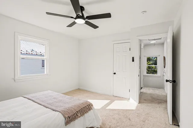 a bedroom with a bed and a chandelier fan