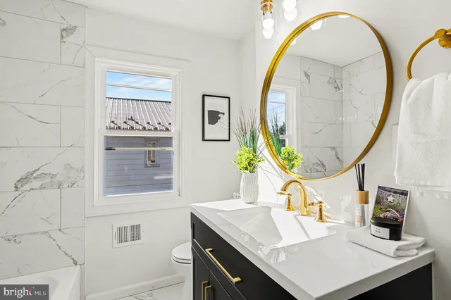 a bathroom with a sink a vanity and a mirror