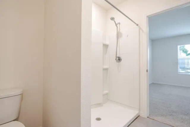a bathroom with a shower and toilet