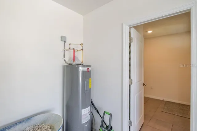 a view of a yard in front of a house with a large tree