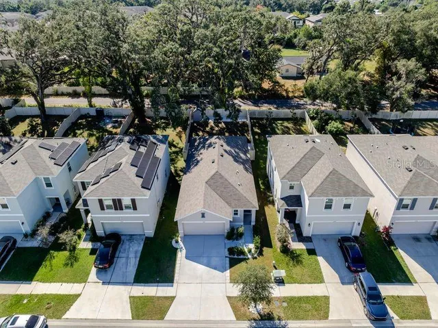 an aerial view of residential houses with outdoor space