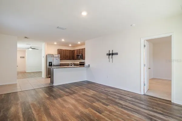 a view of a kitchen with a sink and a refrigerator