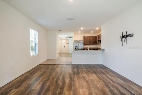 a view of kitchen with wooden floor and electronic appliances