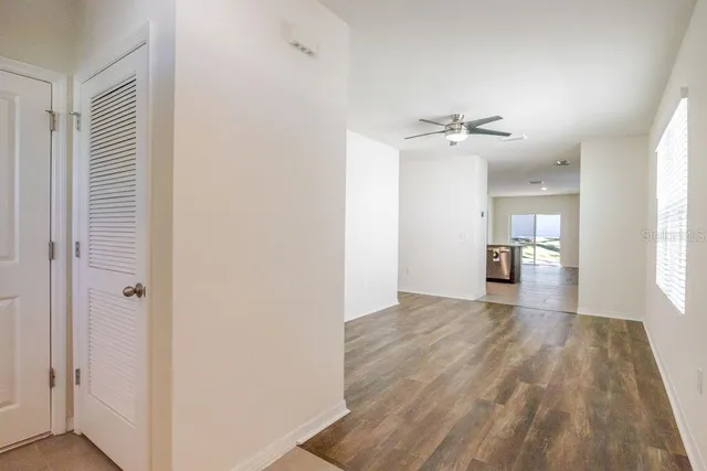 a view of a kitchen with a sink and wooden floor
