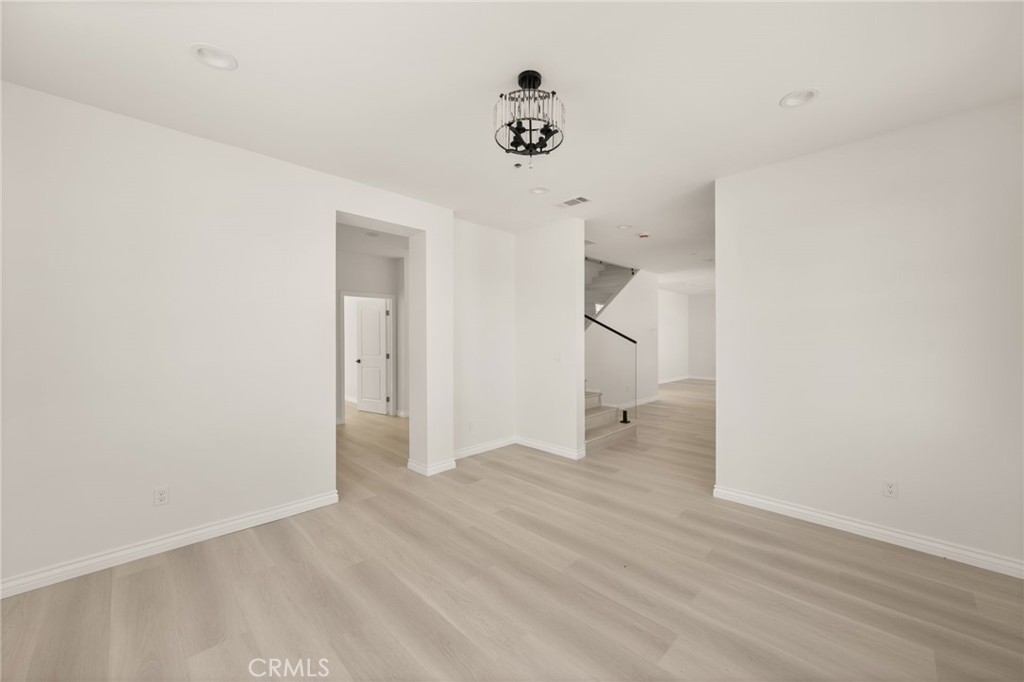 5978 Copperfield Avenue Riverside, CA 92506 - Photo 17 of 37 a view of an empty room with wooden floor and a ceiling fan