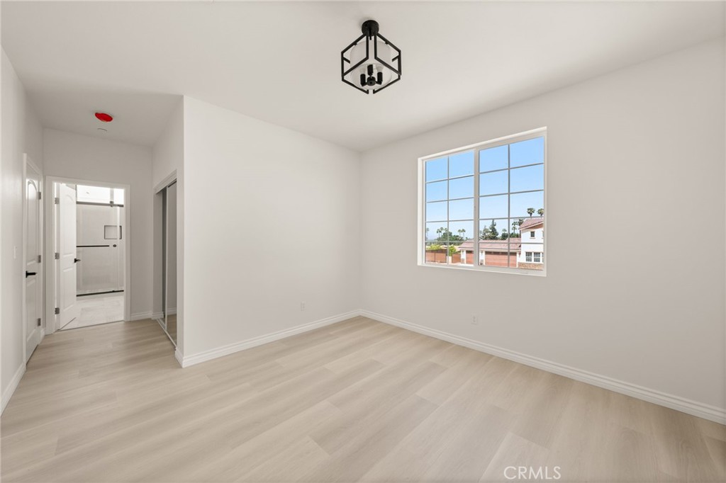5978 Copperfield Avenue Riverside, CA 92506 - Photo 23 of 37 wooden floor in an empty room with a window