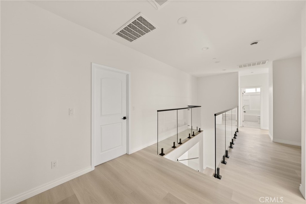 5978 Copperfield Avenue Riverside, CA 92506 - Photo 25 of 37 a view of staircase with white walls and railing