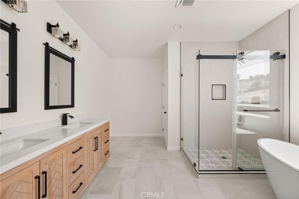5978 Copperfield Avenue Riverside, CA 92506 - Photo 26 of 37 a bathroom with a double vanity sink mirror and shower