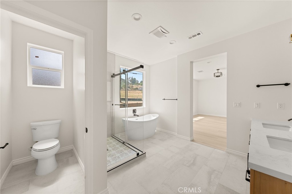 5978 Copperfield Avenue Riverside, CA 92506 - Photo 27 of 37 a white toilet sitting next to a bathroom sink