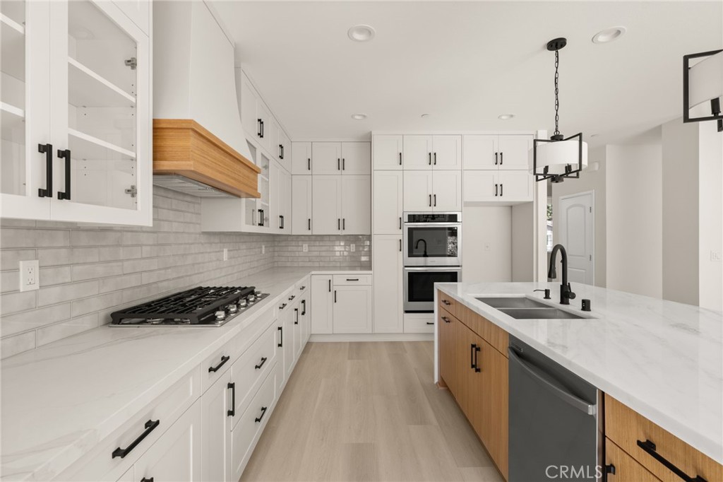 5978 Copperfield Avenue Riverside, CA 92506 - Photo 6 of 37 a kitchen with stainless steel appliances a sink stove and refrigerator