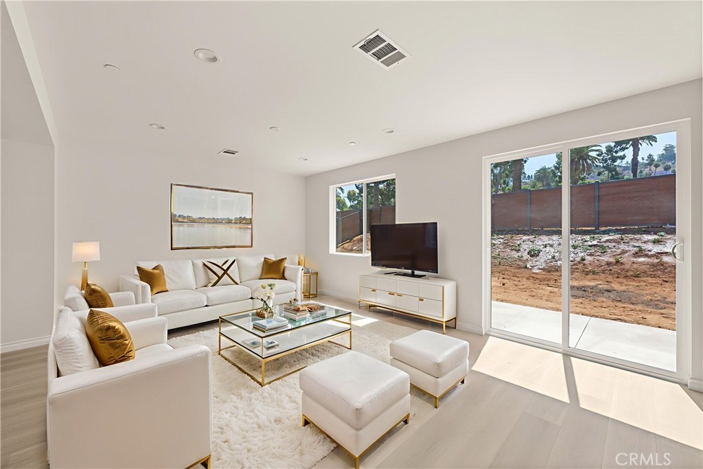 5978 Copperfield Avenue Riverside, CA 92506 - Photo 9 of 37 a living room with furniture and a flat screen tv