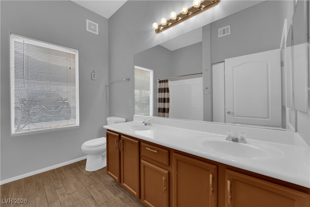 2305 West Horizon Ridge Parkway, Unit 3512 Henderson, NV 89052 - Photo 12 of 29 Full bath featuring double vanity, light wood-style flooring, and a shower with shower curtain