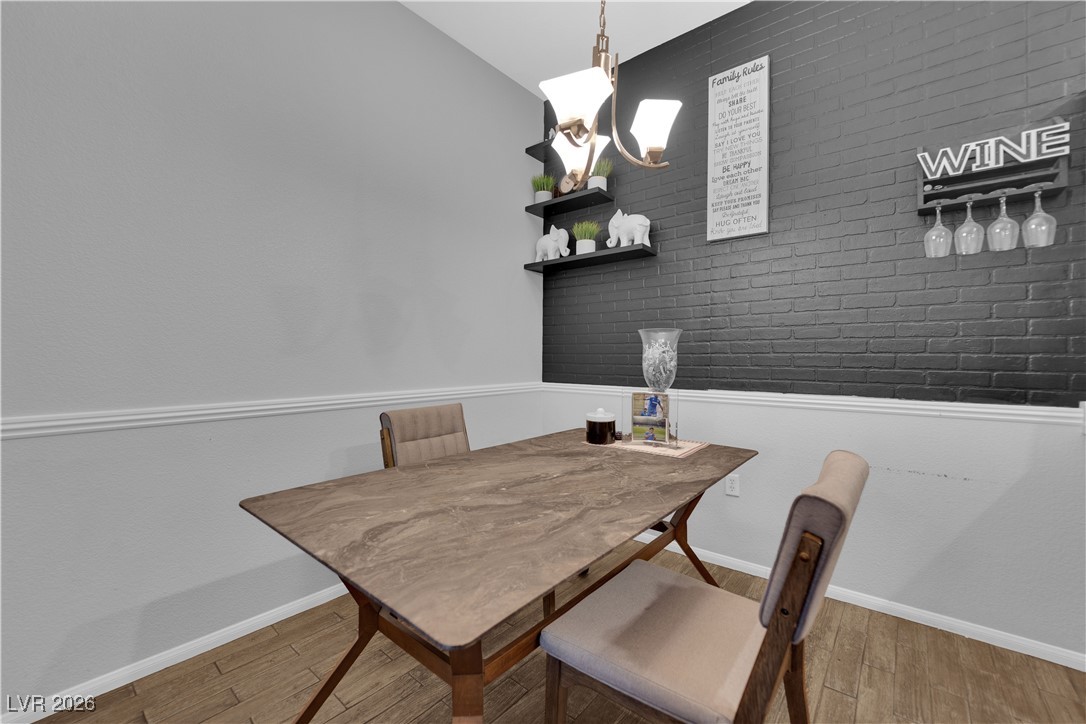 2305 West Horizon Ridge Parkway, Unit 3512 Henderson, NV 89052 - Photo 16 of 29 Dining space with brick wall and light wood-style flooring