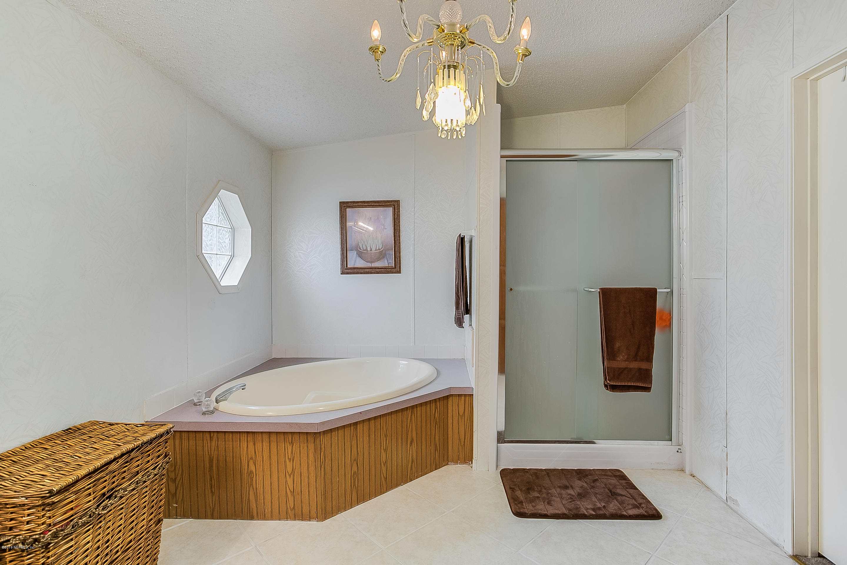 13278 Grover Road Jacksonville, FL 32226 - Photo 13 of 26 a bathroom with a tub and a mirror