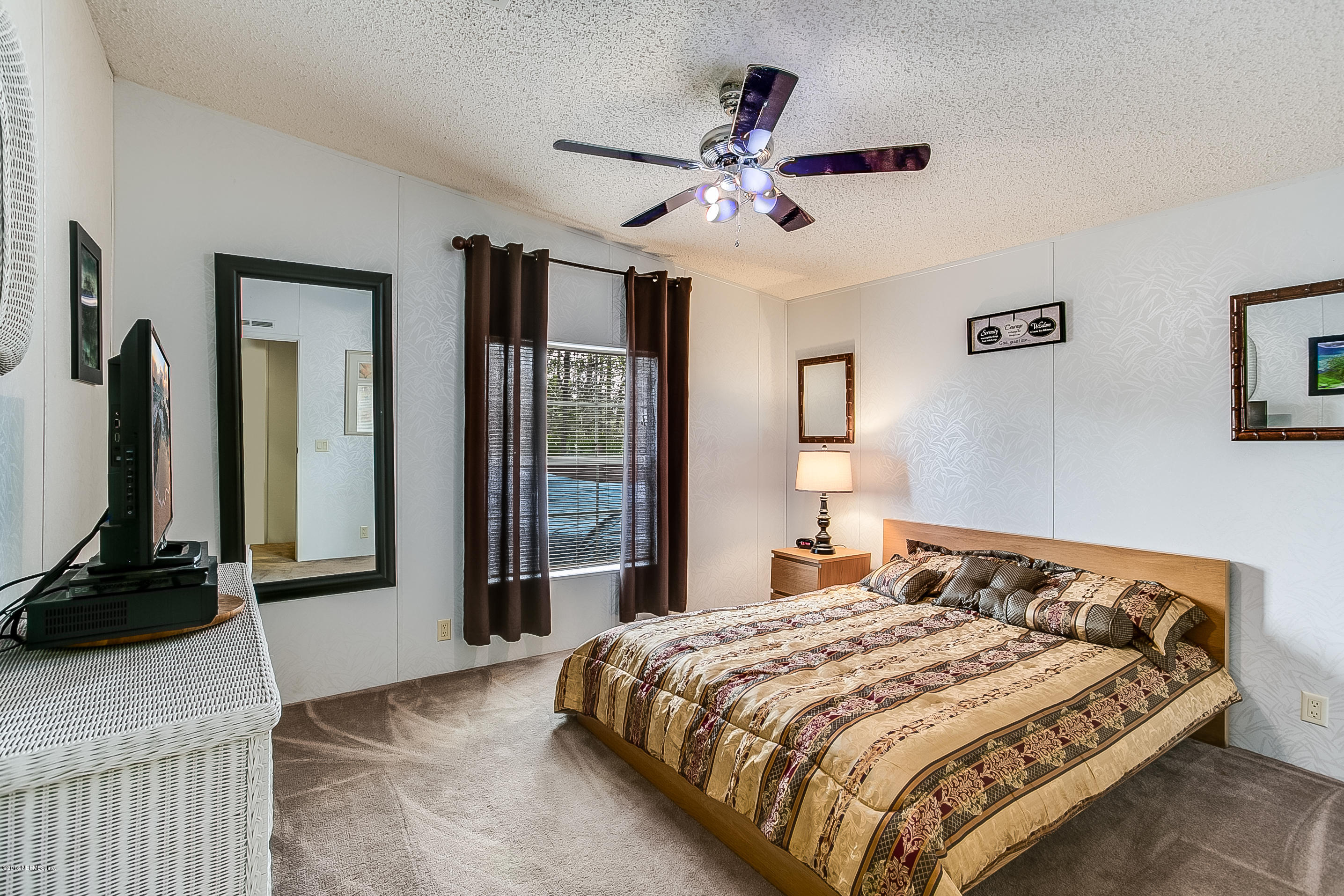 13278 Grover Road Jacksonville, FL 32226 - Photo 15 of 26 a bedroom with a bed and a chandelier