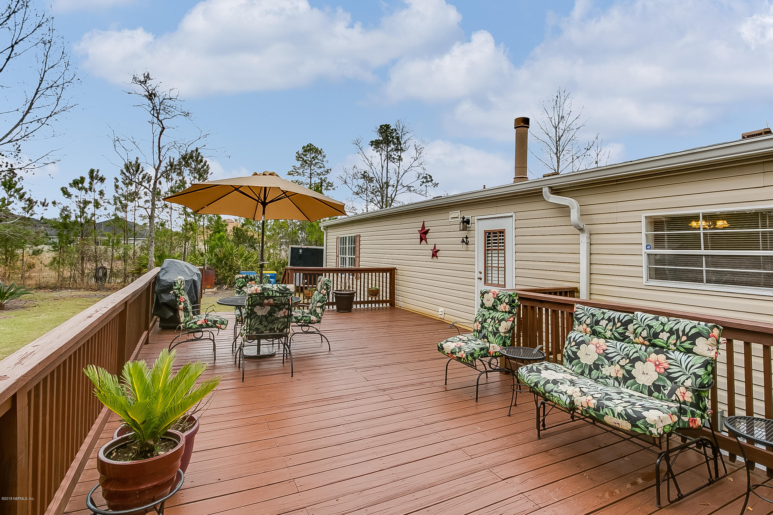 13278 Grover Road Jacksonville, FL 32226 - Photo 21 of 26 an outdoor space with furniture and umbrella