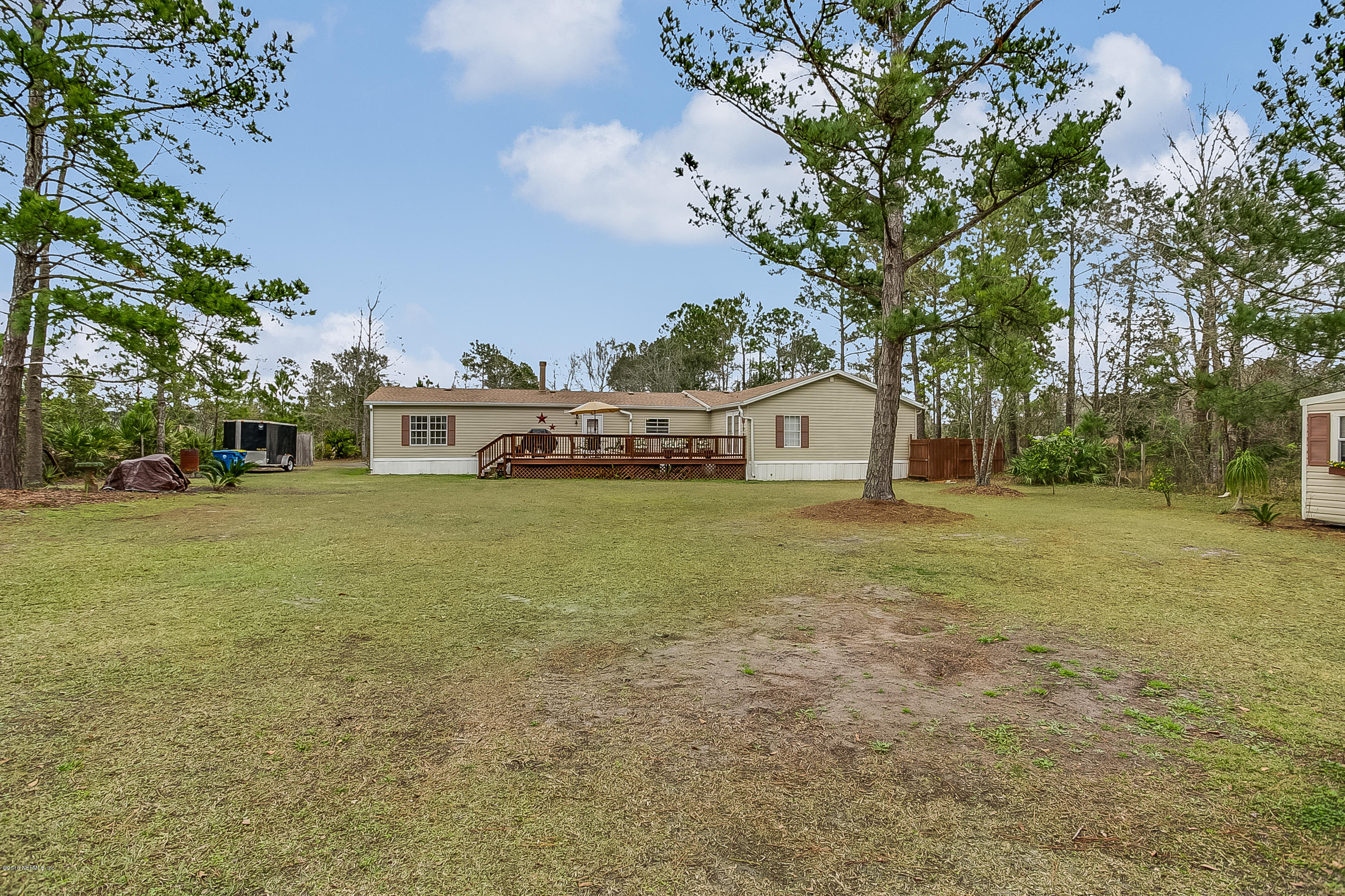 13278 Grover Road Jacksonville, FL 32226 - Photo 25 of 26 a white house with a big yard and large trees