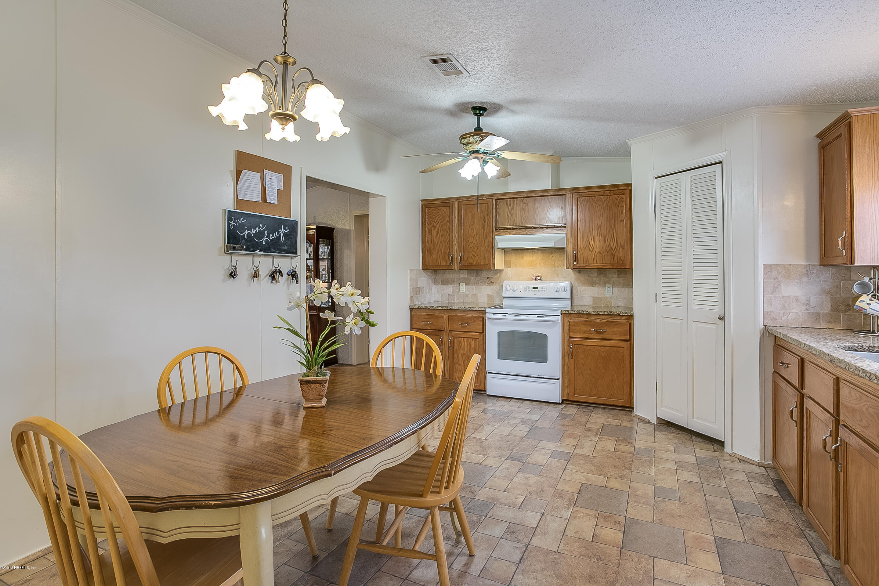 13278 Grover Road Jacksonville, FL 32226 - Photo 5 of 26 a view of a dining room with furniture and chandelier