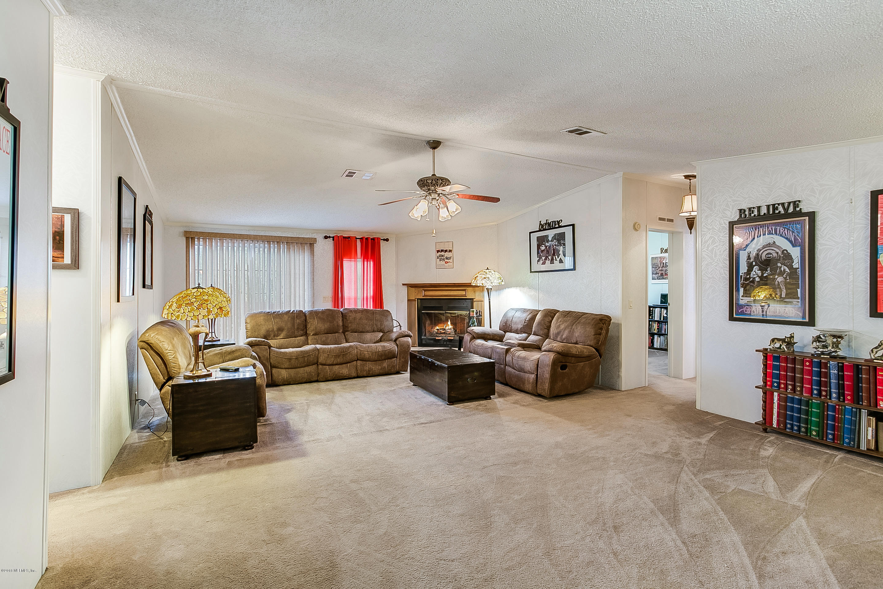 13278 Grover Road Jacksonville, FL 32226 - Photo 7 of 26 a living room with furniture and a flat screen tv