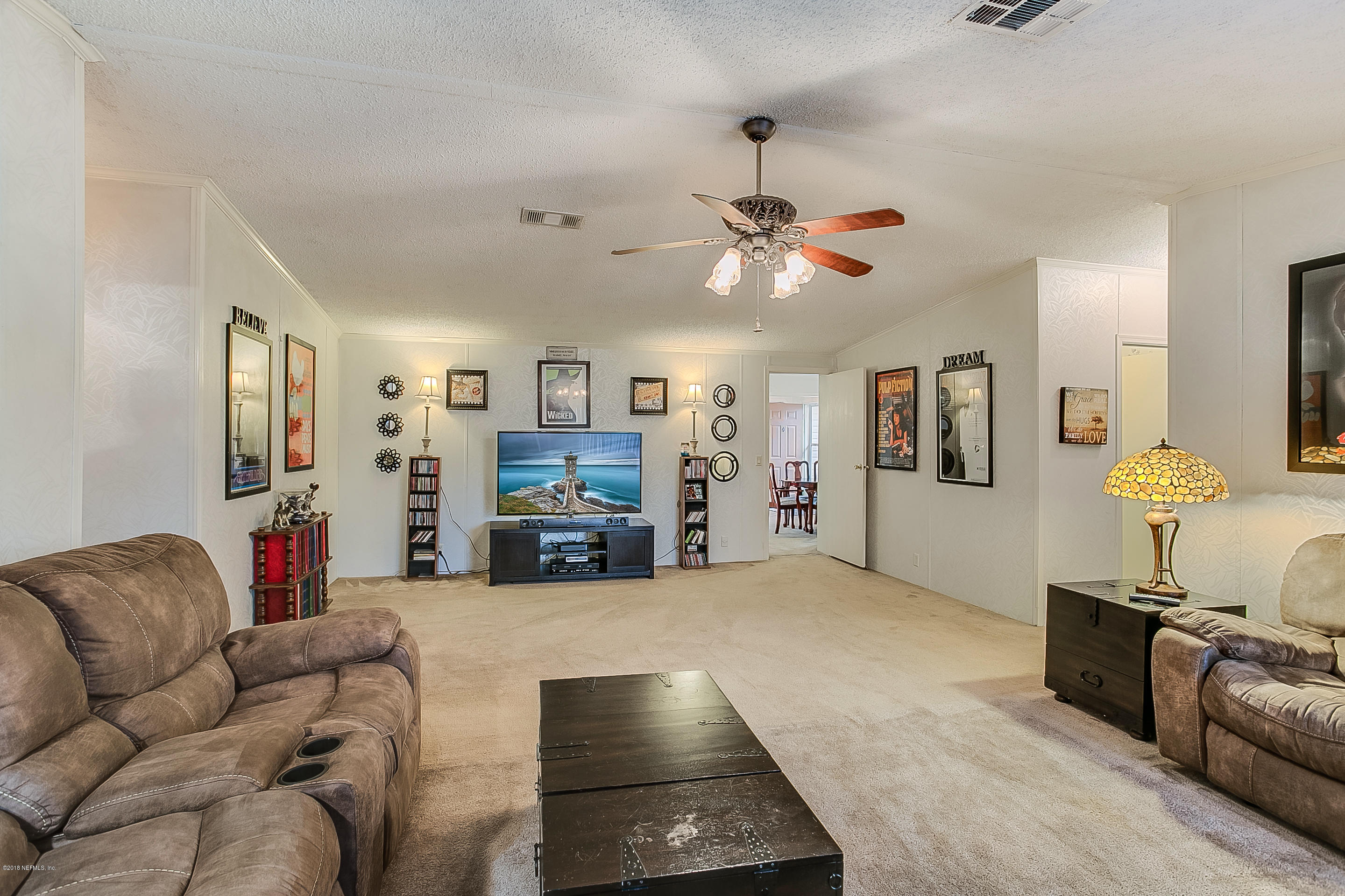 13278 Grover Road Jacksonville, FL 32226 - Photo 8 of 26 a living room with furniture and a flat screen tv