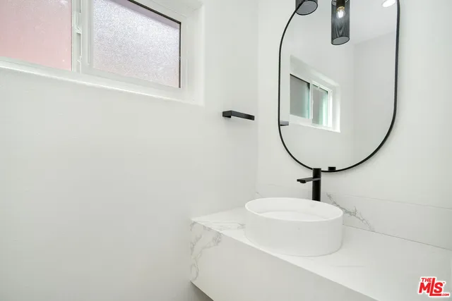 a bathroom with a sink a mirror and vanity