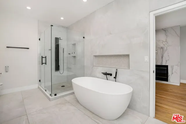 a bathroom with a bathtub and shower